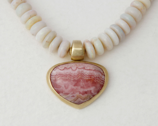 large gold necklace with milky Opal beads and an Argentina-Rhodochrosite central stone